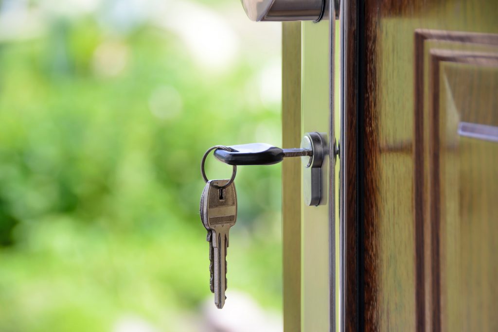 Buying a Home Property in Sarasota FL Black Handled Key on Key Hole